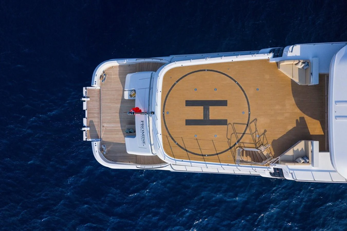 The yacht features a spacious helipad on its upper deck, offering a luxurious touch for seamless travel. aboard PROMISE Yacht for Sale