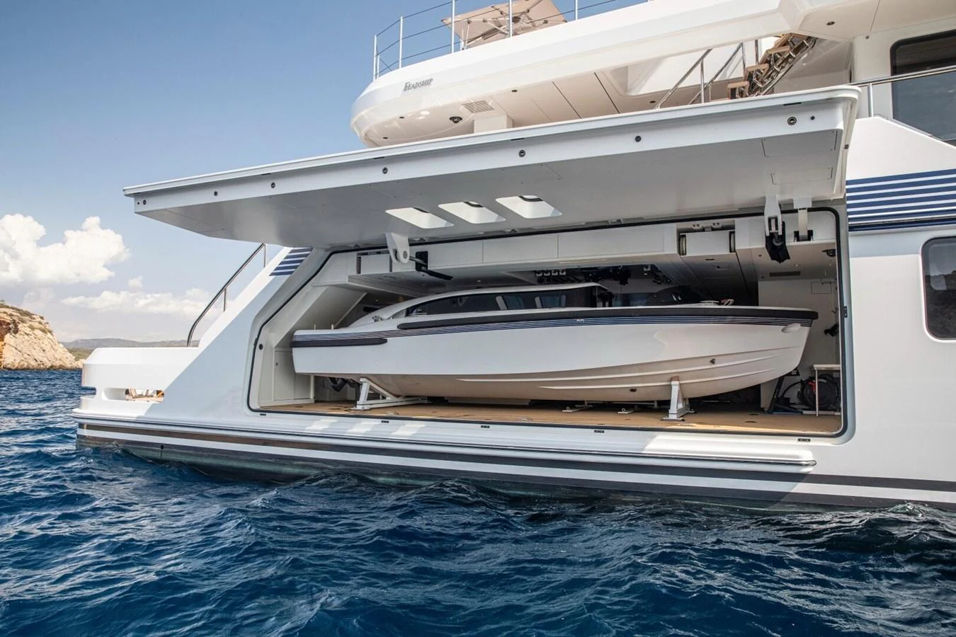 The yacht features a spacious garage with a sleek tender ready for deployment. aboard PROMISE Yacht for Sale