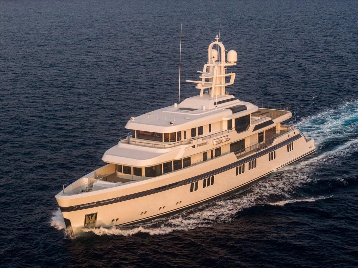 A luxurious yacht cruises through the open sea, showcasing its elegant design and spacious decks. aboard PROMISE Yacht for Sale