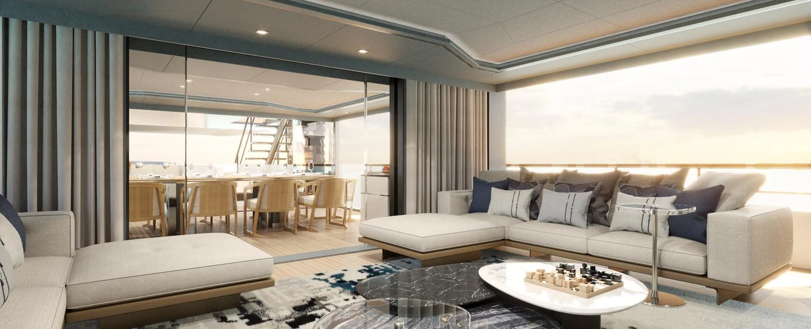 The salon features luxurious seating with a view of the dining area and the ocean beyond. aboard SPITFIRE Yacht for Sale