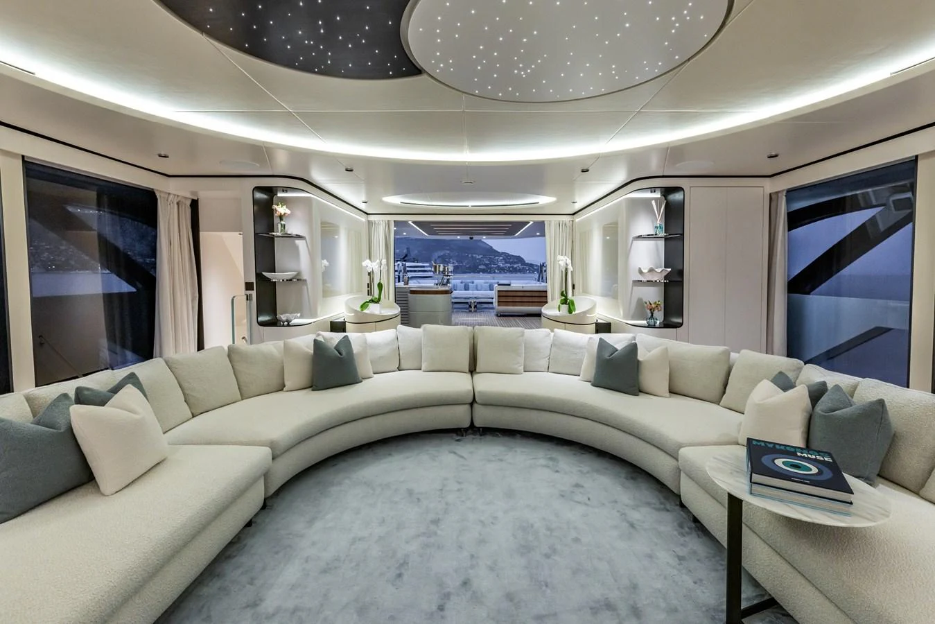 a living room with a large white sofa and a large window aboard FELICITA Yacht for Sale