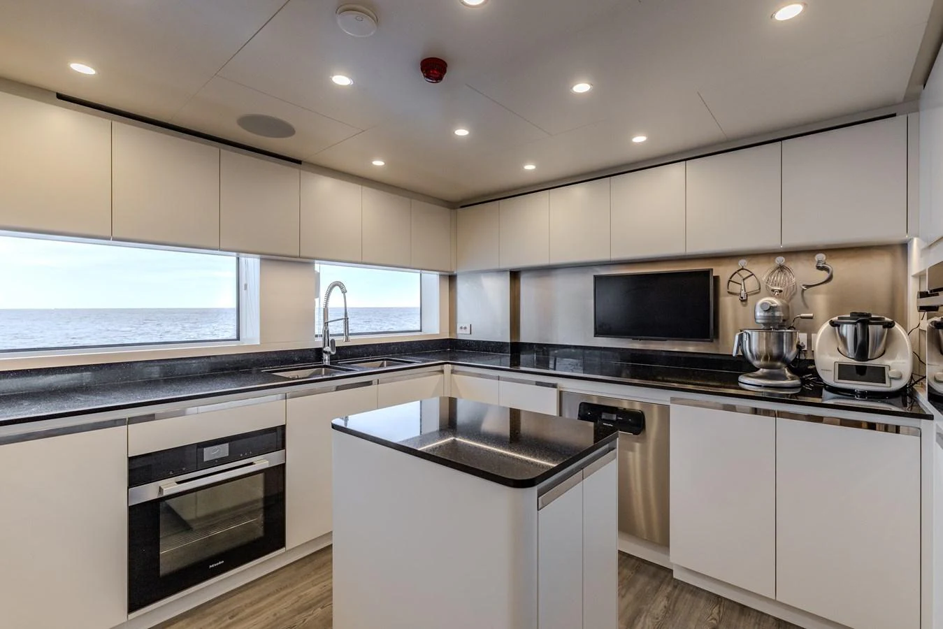 a kitchen with white cabinets aboard FELICITA Yacht for Sale