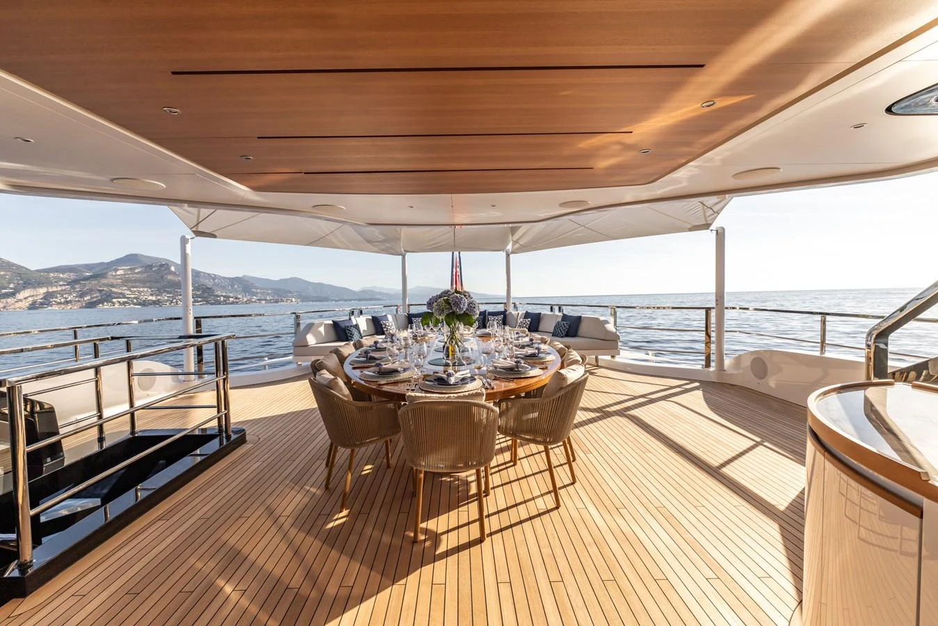 a deck with a table and chairs on it aboard FELICITA Yacht for Sale