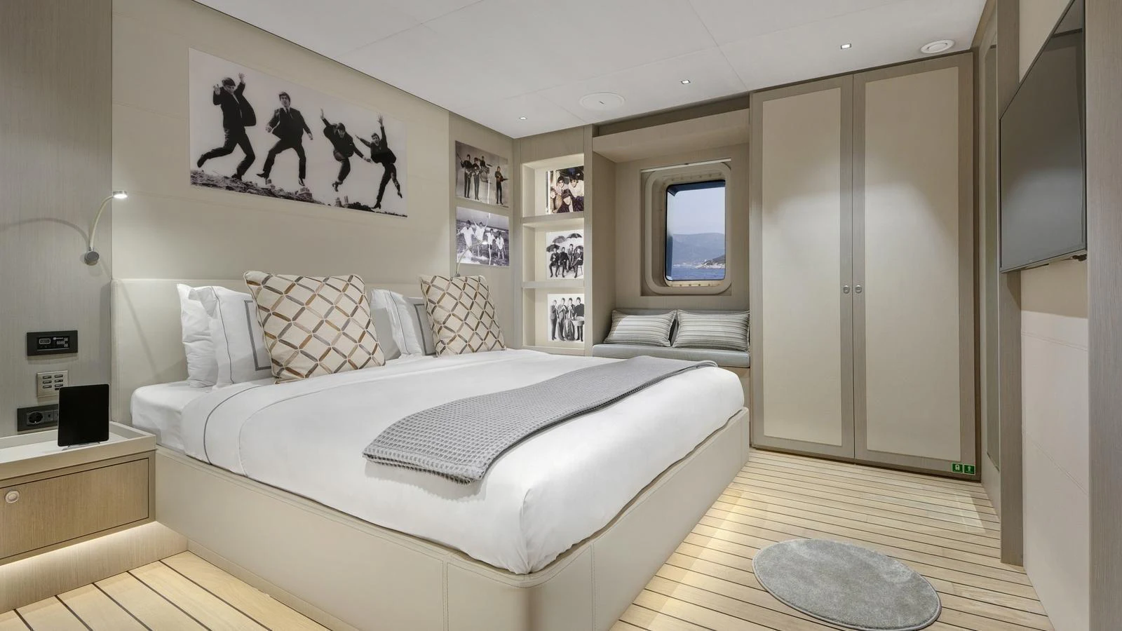 The stateroom features a spacious bed, modern decor, and ample natural light from the window. aboard ALL ABOUT U Yacht for Sale