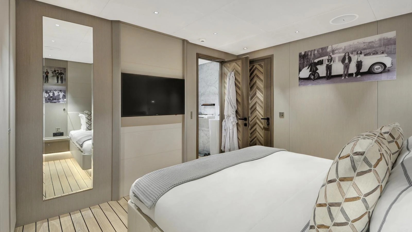 A luxurious stateroom featuring a comfortable bed, modern decor, and a flat-screen TV. aboard ALL ABOUT U Yacht for Sale