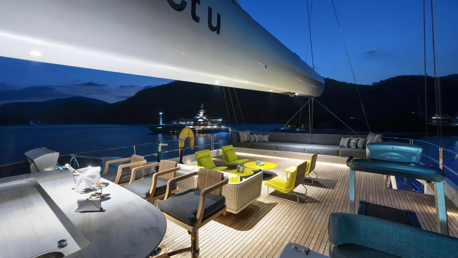 The aft deck offers a luxurious outdoor seating area with stunning evening views. aboard ALL ABOUT U Yacht for Sale