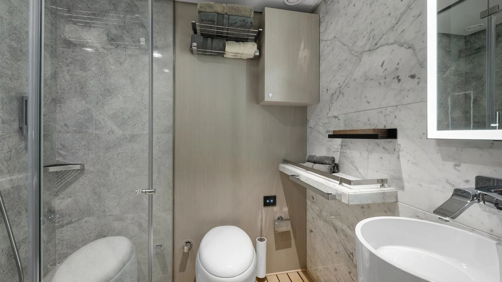 The yacht's bathroom features elegant marble walls and modern fixtures. aboard ALL ABOUT U Yacht for Sale