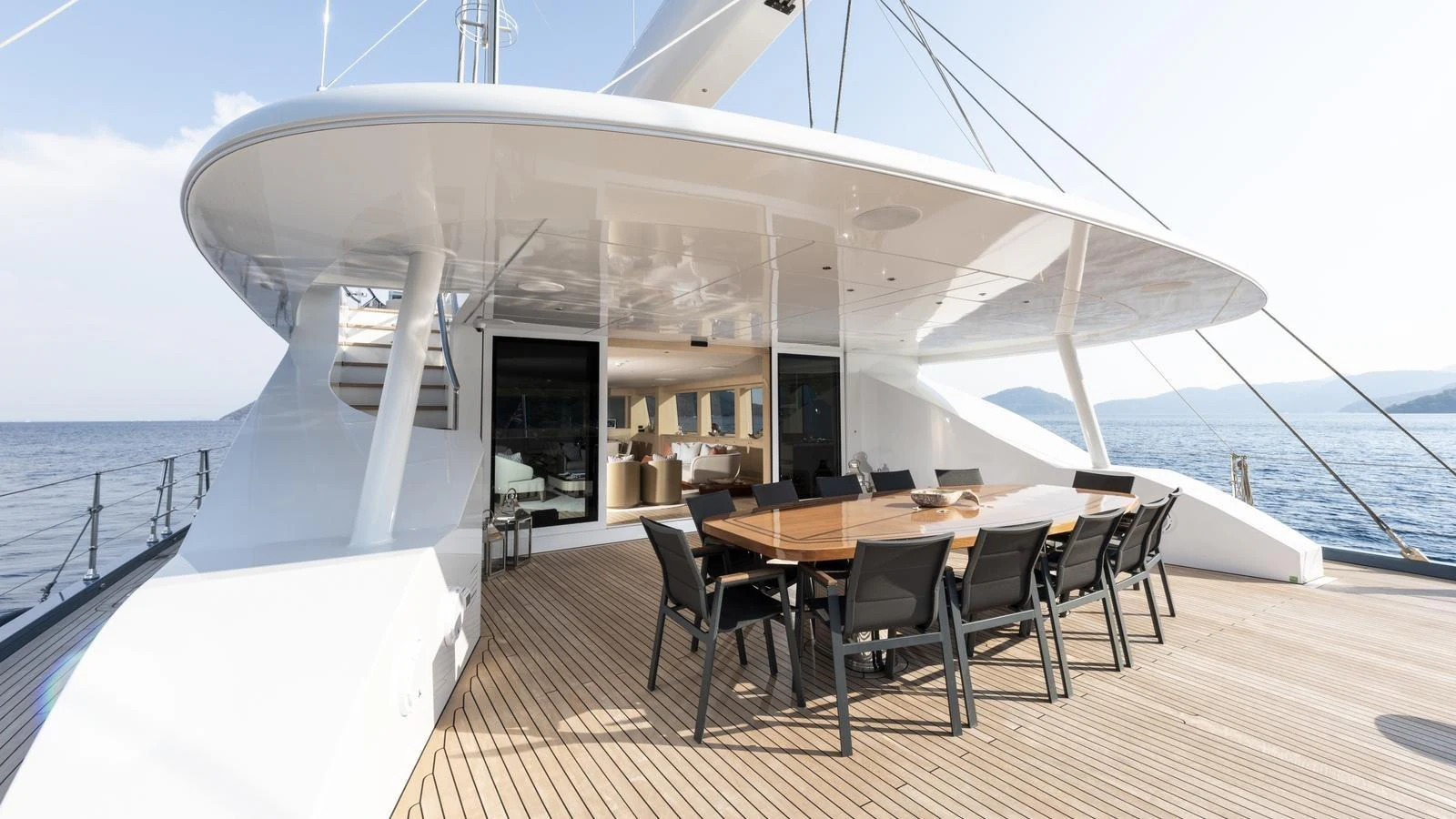 The spacious aft deck features a large dining table with comfortable seating, perfect for alfresco dining. aboard ALL ABOUT U Yacht for Sale