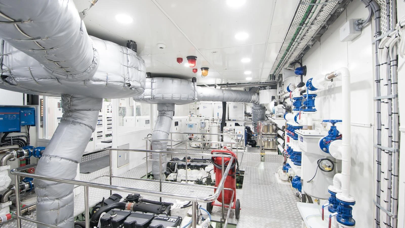 The image showcases a pristine and well-organized engine room with advanced machinery and piping. aboard ALL ABOUT U Yacht for Sale