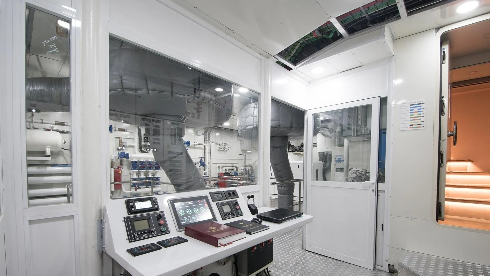 The yacht's engine room features advanced control panels and a clean, organized layout. aboard ALL ABOUT U Yacht for Sale