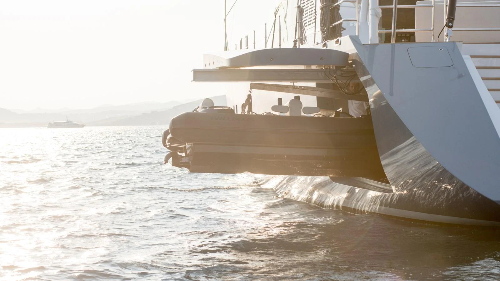 A sleek tender is being deployed from the yacht's side, ready for an adventure on the water. aboard ALL ABOUT U Yacht for Sale