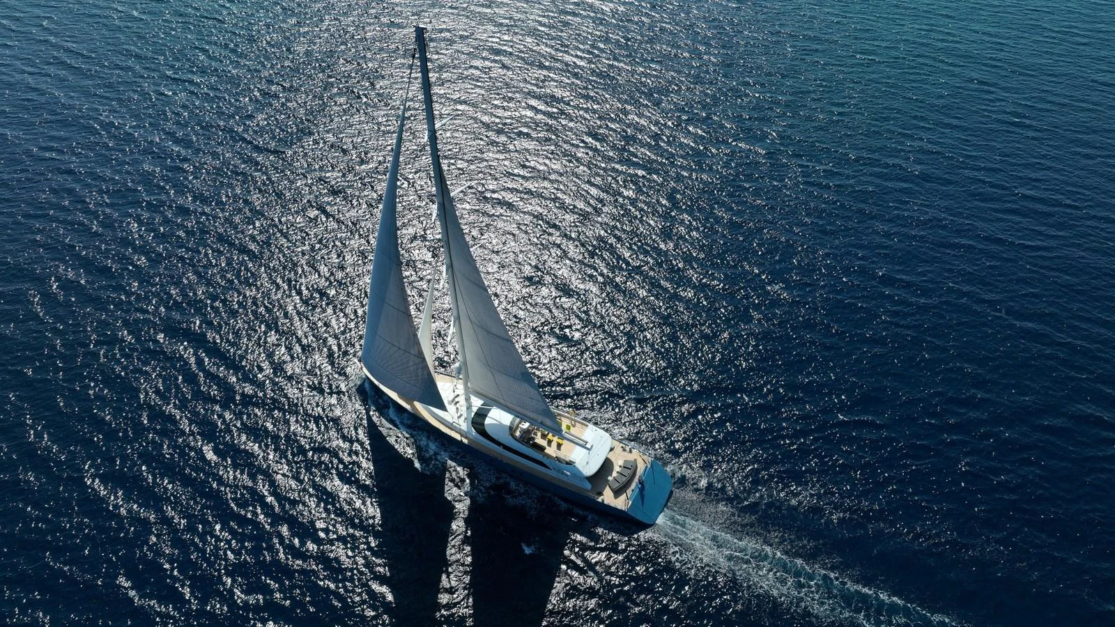 A stunning sailing yacht gracefully glides over the shimmering blue sea. aboard ALL ABOUT U Yacht for Sale