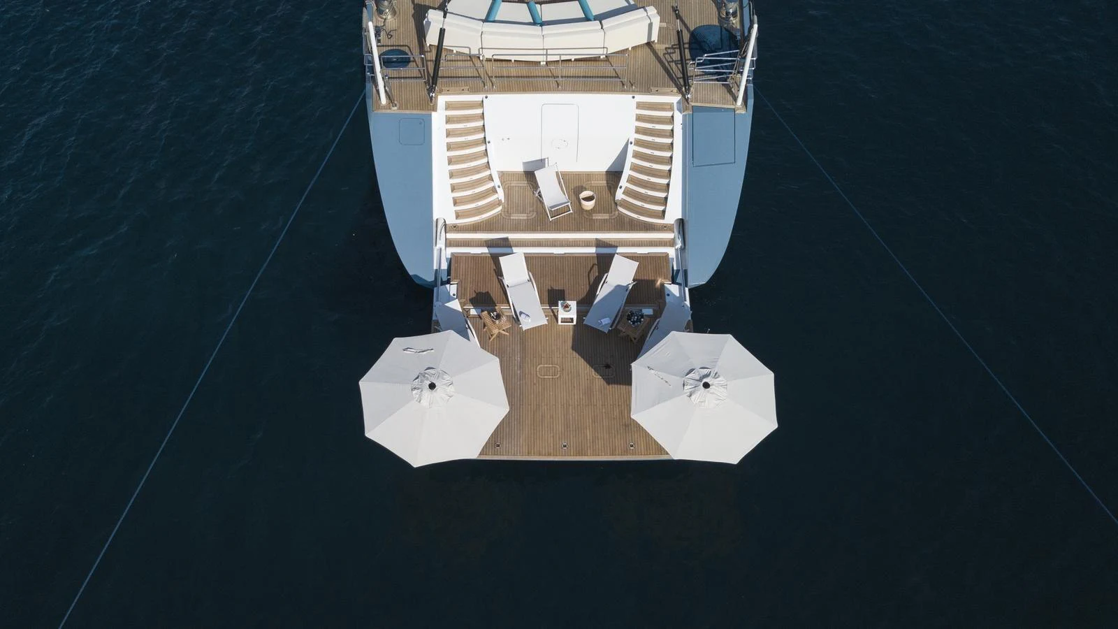 The yacht's aft deck features a spacious lounging area with sunbeds and umbrellas, perfect for relaxation. aboard ALL ABOUT U Yacht for Sale