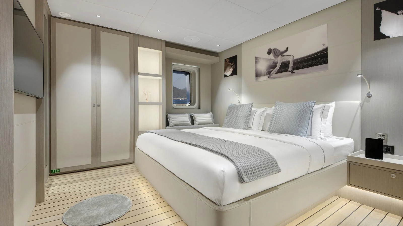 A luxurious stateroom featuring a large bed, modern decor, and ample storage space. aboard ALL ABOUT U Yacht for Sale
