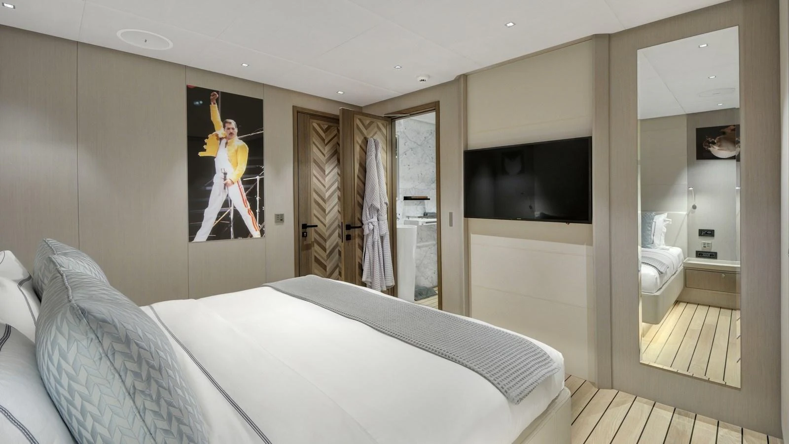 The stateroom features a comfortable bed, modern decor, and a large mirror, creating a cozy and stylish retreat. aboard ALL ABOUT U Yacht for Sale