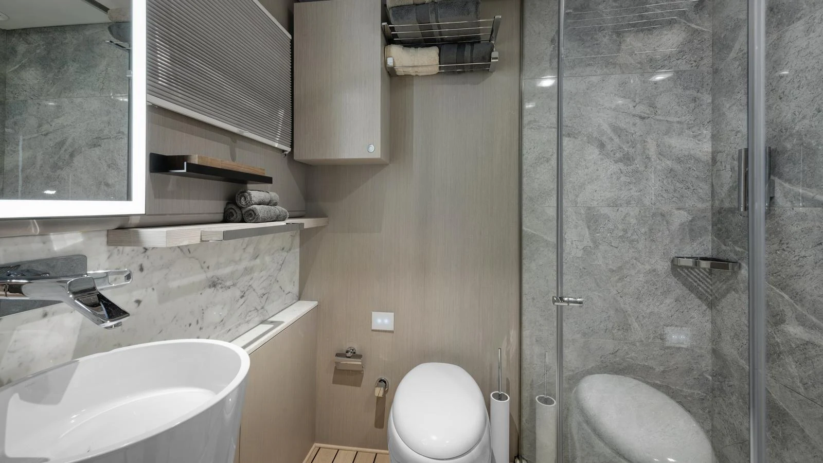 A modern yacht bathroom with sleek fixtures and a glass-enclosed shower. aboard ALL ABOUT U Yacht for Sale