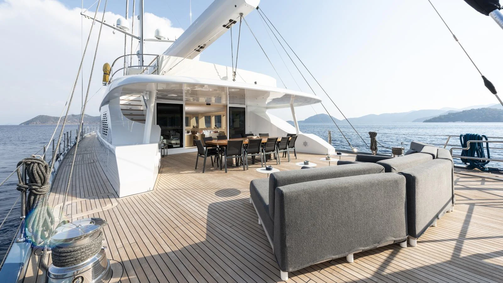 The spacious aft deck features comfortable seating and a dining area, perfect for outdoor relaxation and entertainment. aboard ALL ABOUT U Yacht for Sale