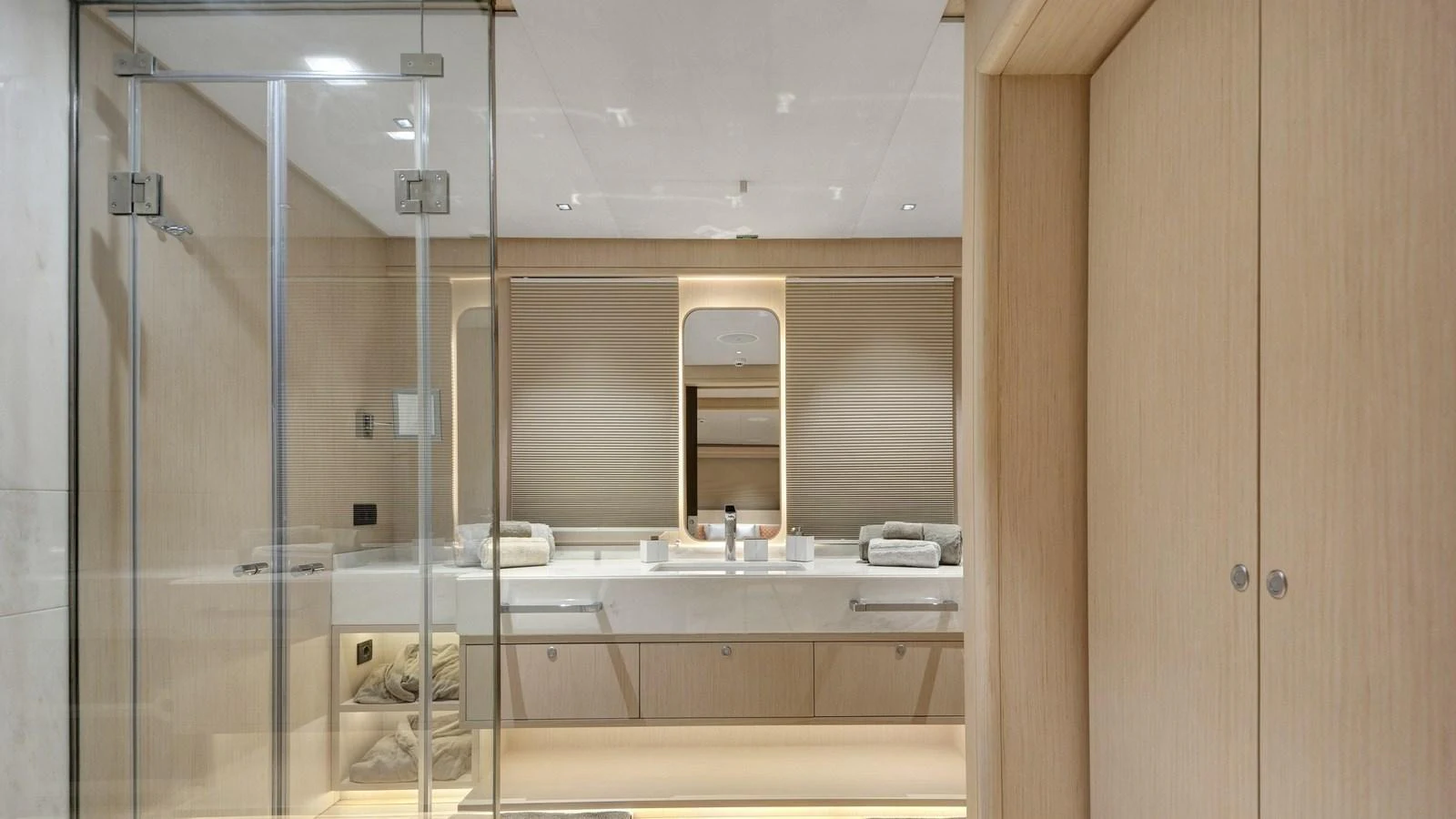 The yacht's bathroom features a sleek, modern design with ample storage and a spacious shower area. aboard ALL ABOUT U Yacht for Sale