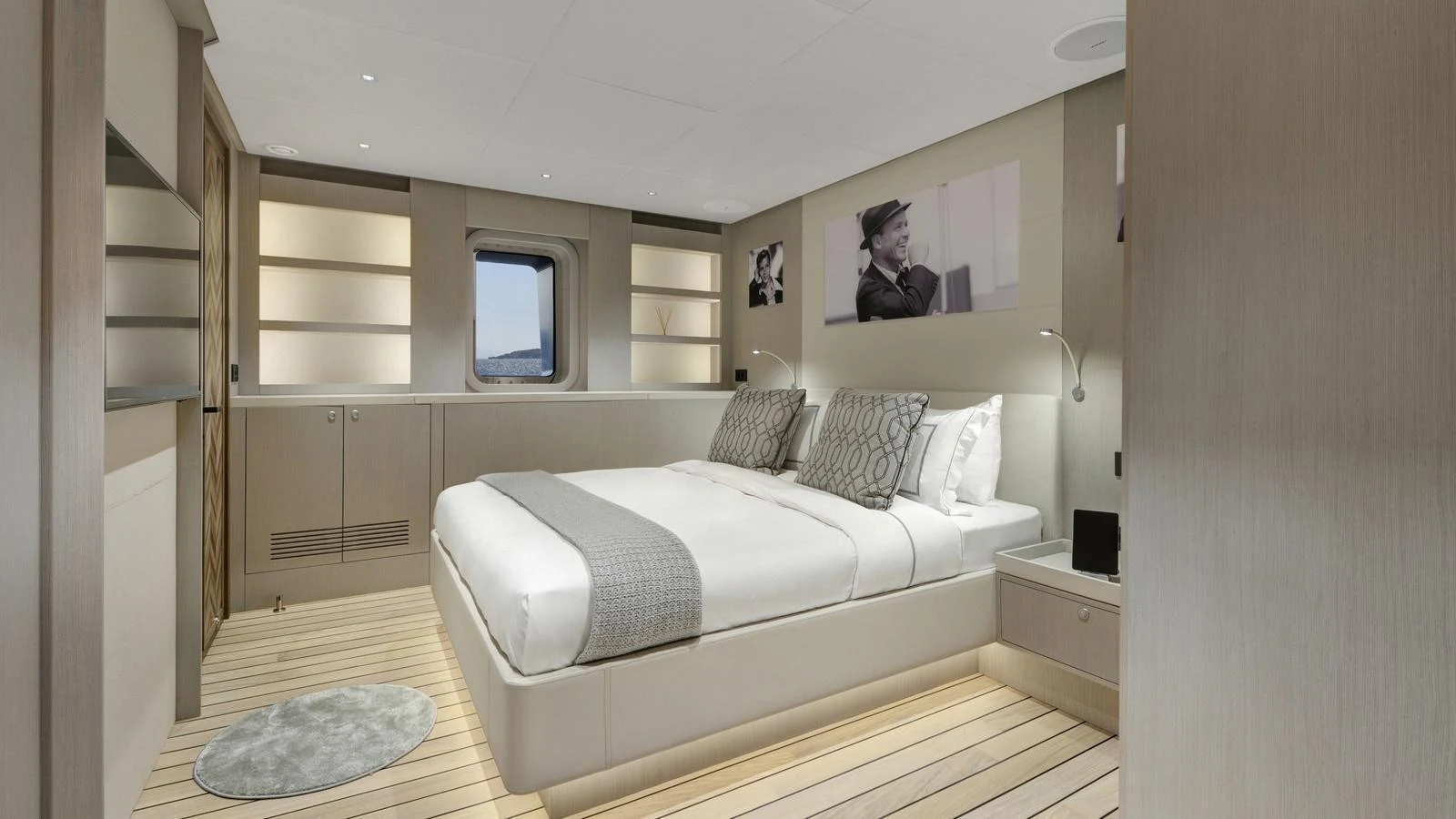 A luxurious stateroom featuring a large bed, modern furnishings, and ambient lighting. aboard ALL ABOUT U Yacht for Sale