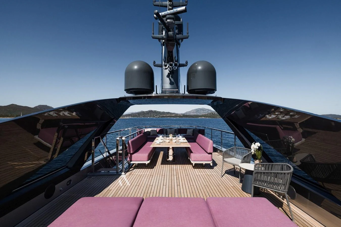 The yacht's aft deck features a luxurious seating area with a dining table, perfect for alfresco dining. aboard FLYING DAGGER III Yacht for Sale