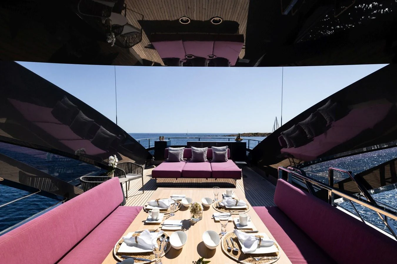 The aft deck offers a luxurious dining area with plush seating and a stunning view of the sea. aboard FLYING DAGGER III Yacht for Sale