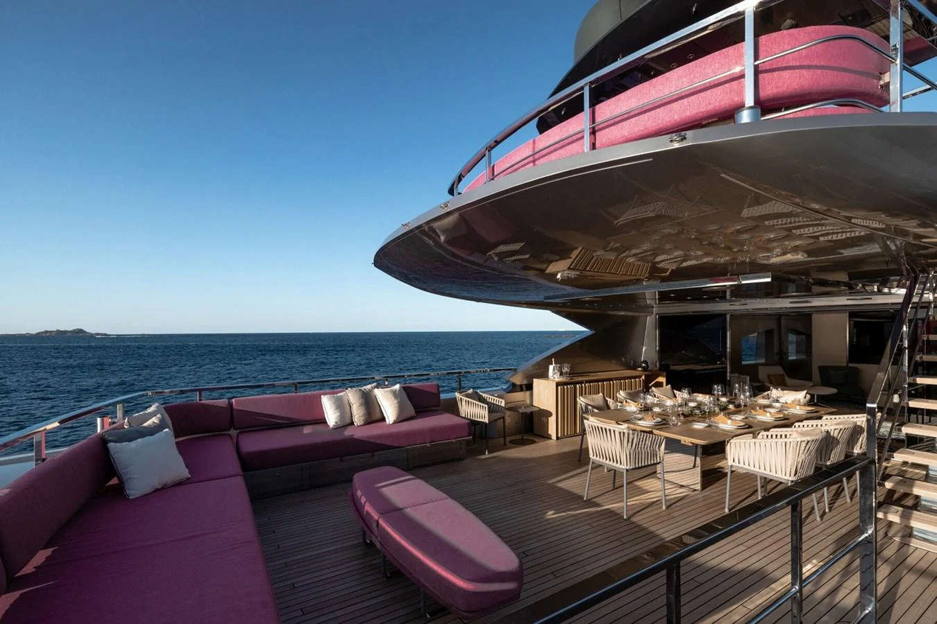 The aft deck features luxurious seating and dining areas with stunning ocean views. aboard FLYING DAGGER III Yacht for Sale