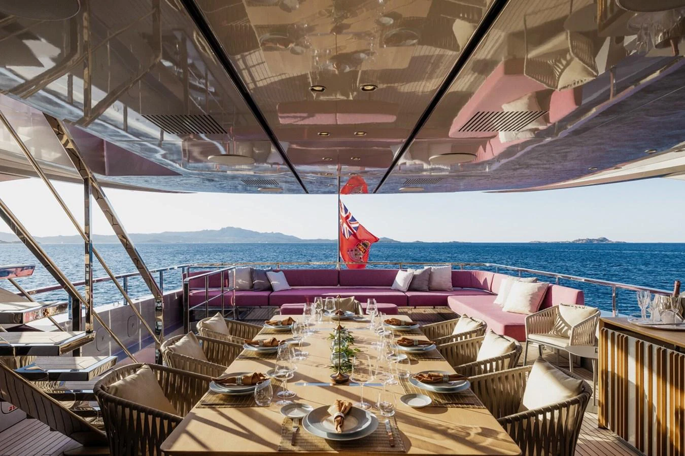 The aft deck offers an elegant dining area with panoramic ocean views. aboard FLYING DAGGER III Yacht for Sale