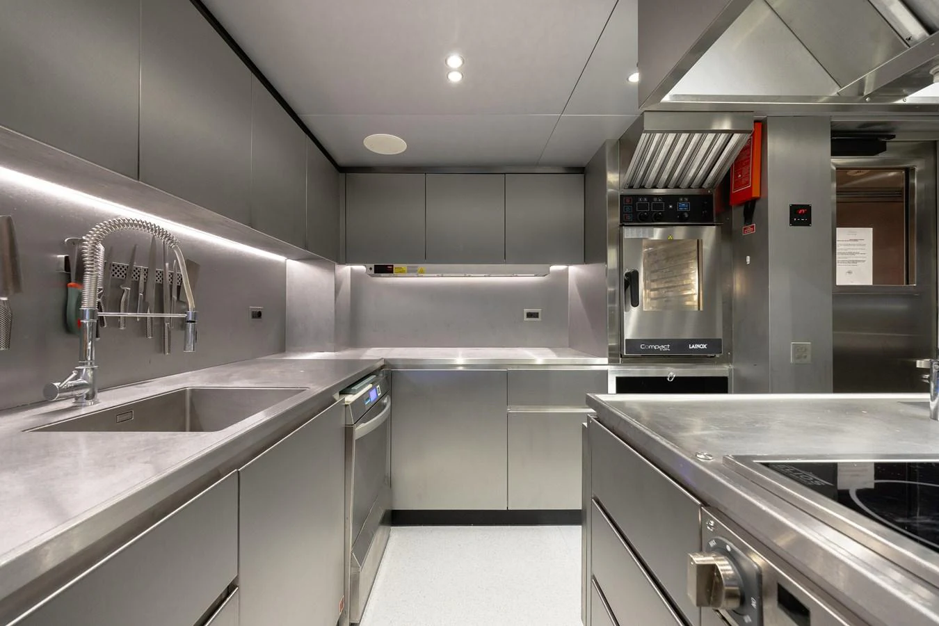 The modern galley features sleek stainless steel appliances and ample counter space. aboard FLYING DAGGER III Yacht for Sale