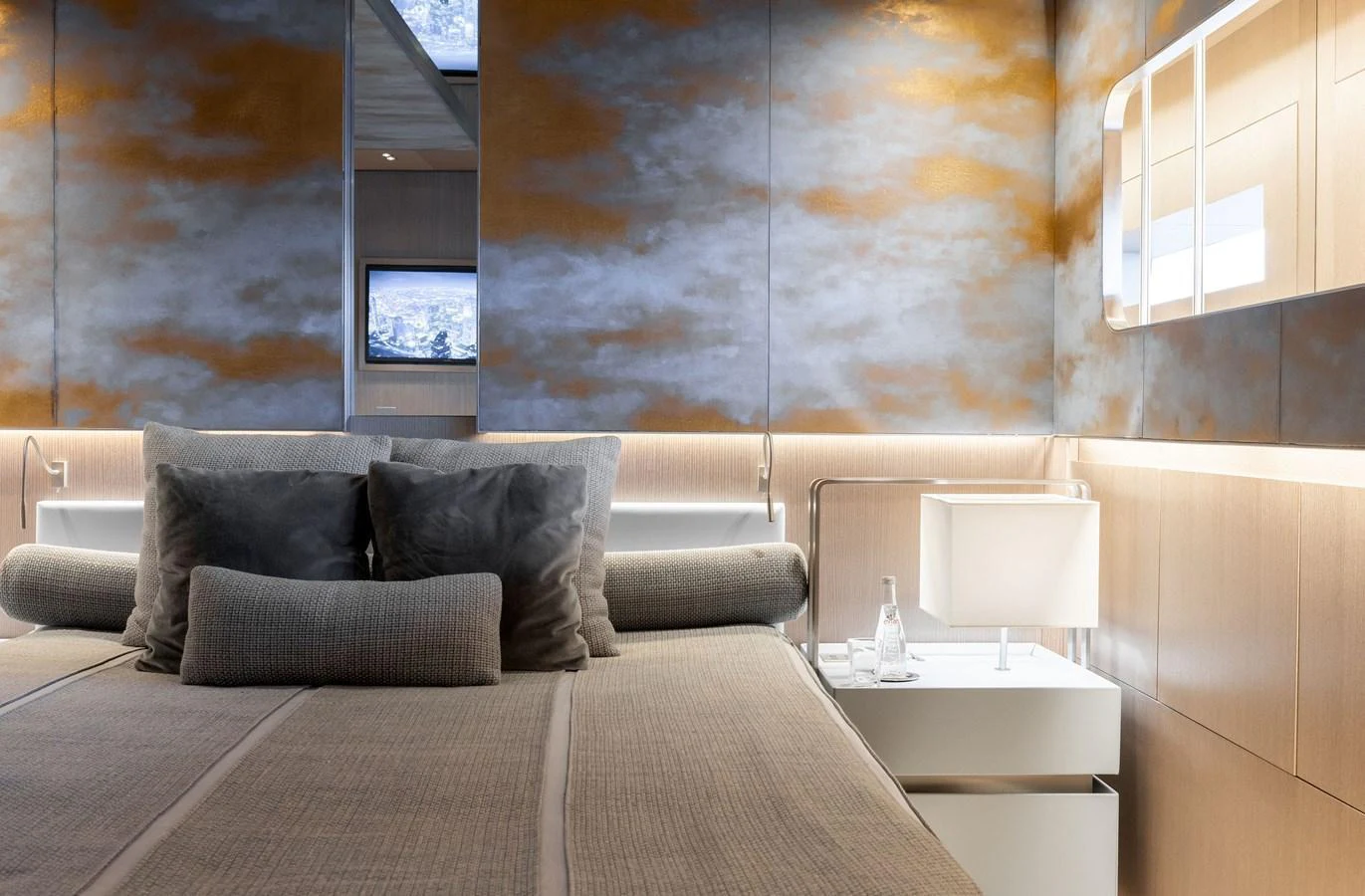 The stateroom features a luxurious bed with plush pillows and modern decor. aboard FLYING DAGGER III Yacht for Sale