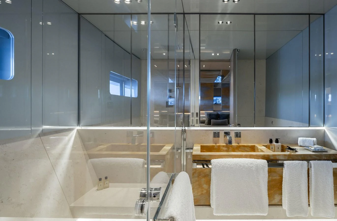The bathroom features sleek, modern design with luxurious finishes and ample lighting. aboard FLYING DAGGER III Yacht for Sale