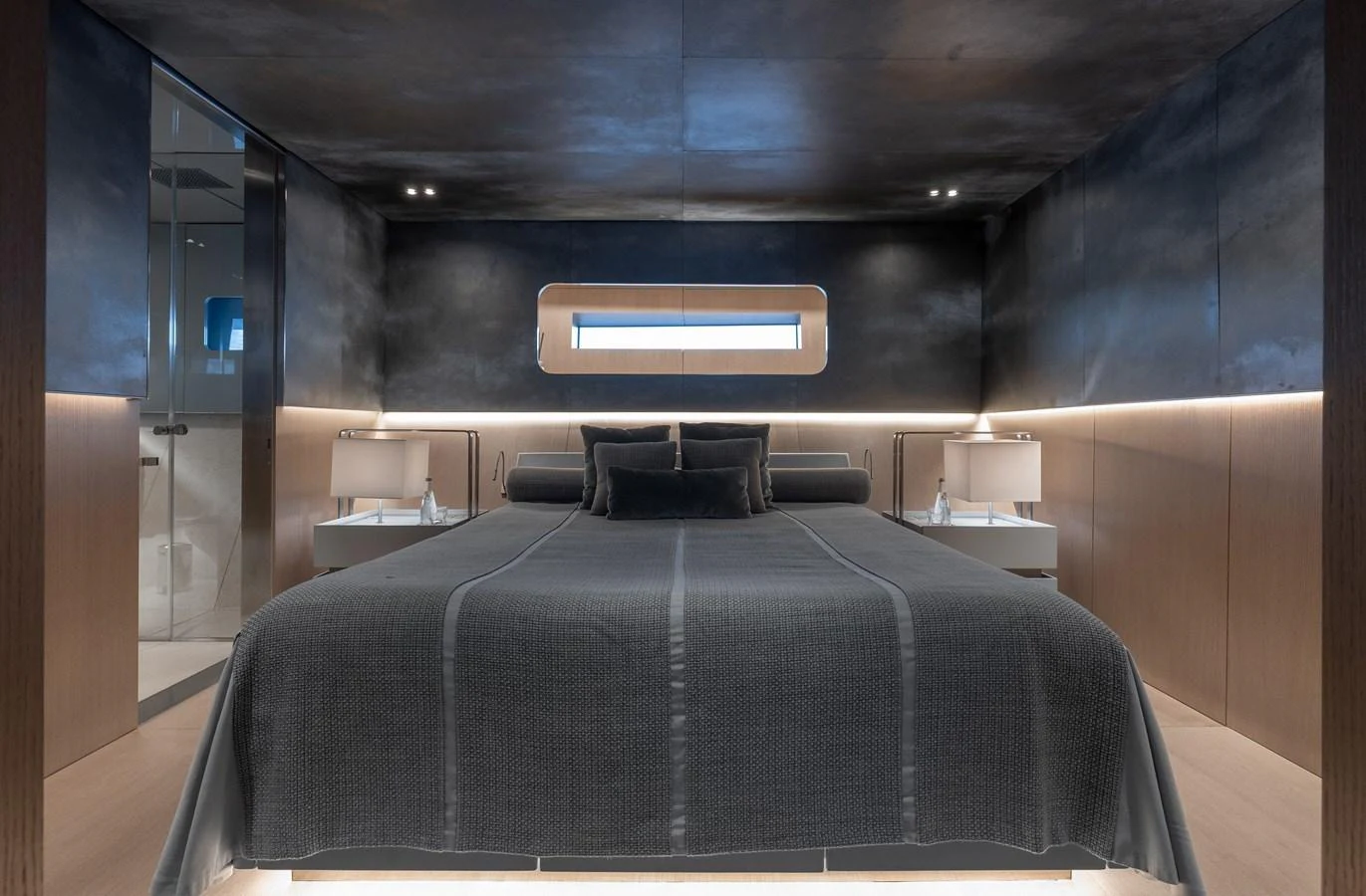 The master stateroom features a sleek, modern design with luxurious bedding and ambient lighting. aboard FLYING DAGGER III Yacht for Sale