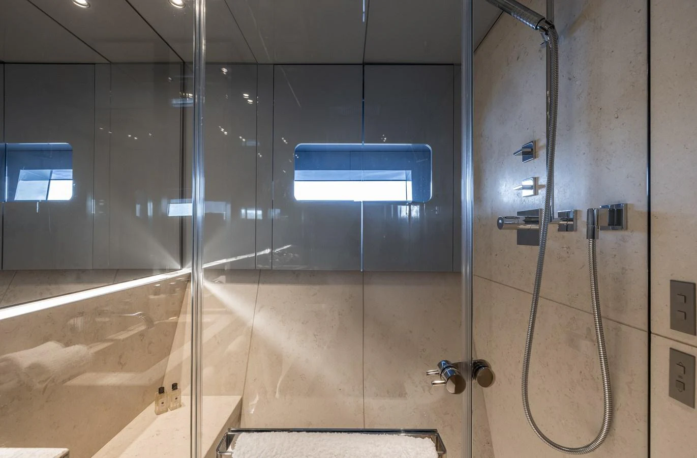 The yacht's bathroom features modern fixtures and a sleek design with a glass-enclosed shower. aboard FLYING DAGGER III Yacht for Sale