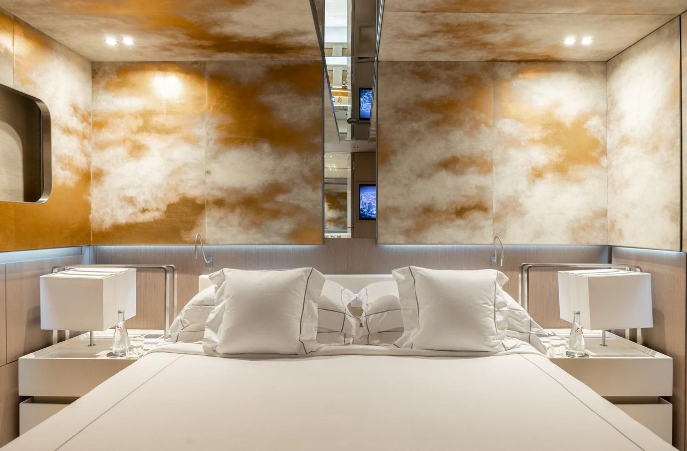 The stateroom features a luxurious bed with elegant lighting and modern decor. aboard FLYING DAGGER III Yacht for Sale