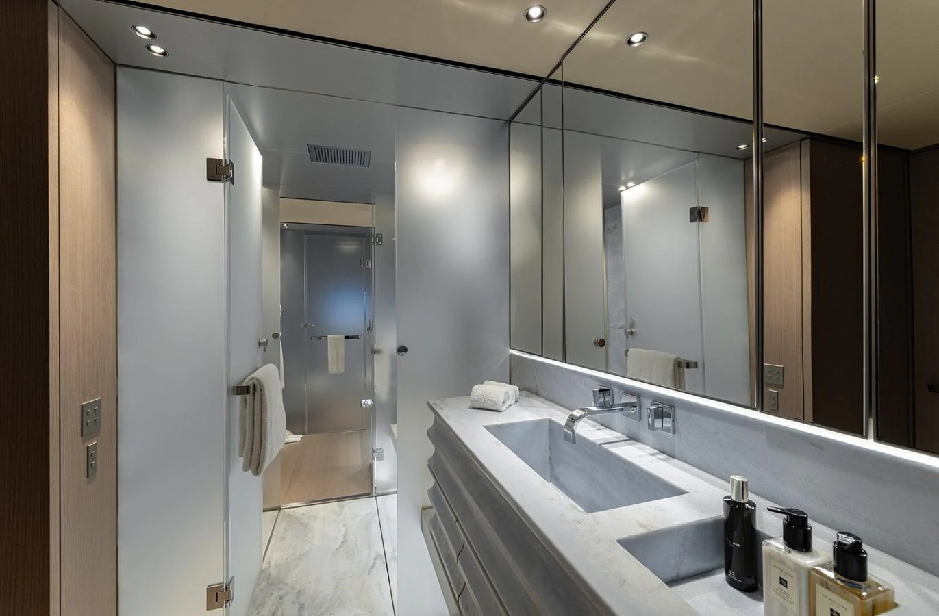 The yacht's bathroom features modern fixtures and a sleek, minimalist design. aboard FLYING DAGGER III Yacht for Sale