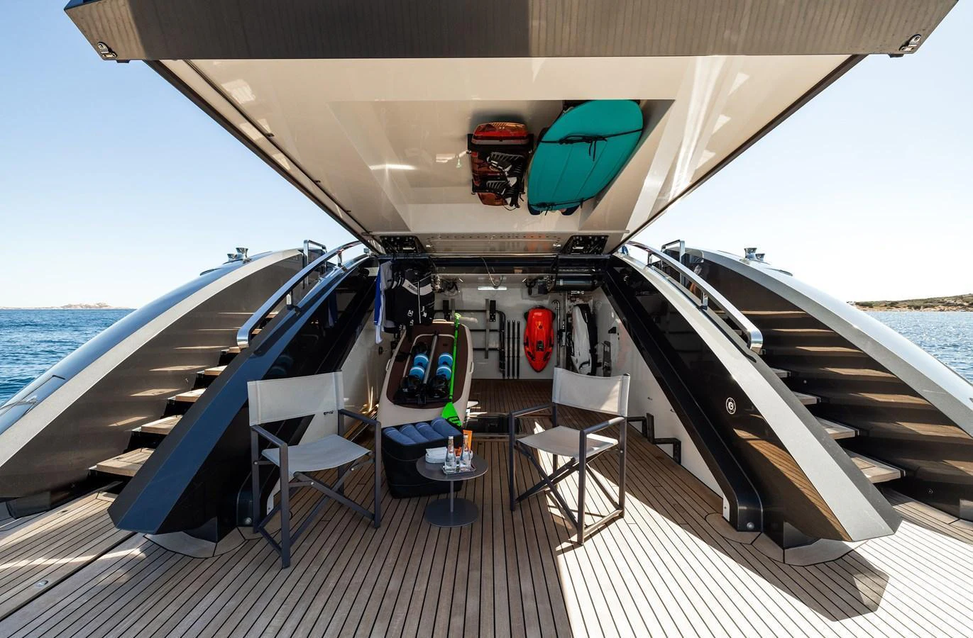 The beach club area features ample storage for water toys and a comfortable seating arrangement for relaxation. aboard FLYING DAGGER III Yacht for Sale