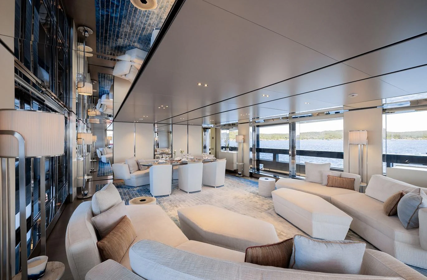 The yacht's salon features luxurious seating with panoramic views of the water. aboard FLYING DAGGER III Yacht for Sale
