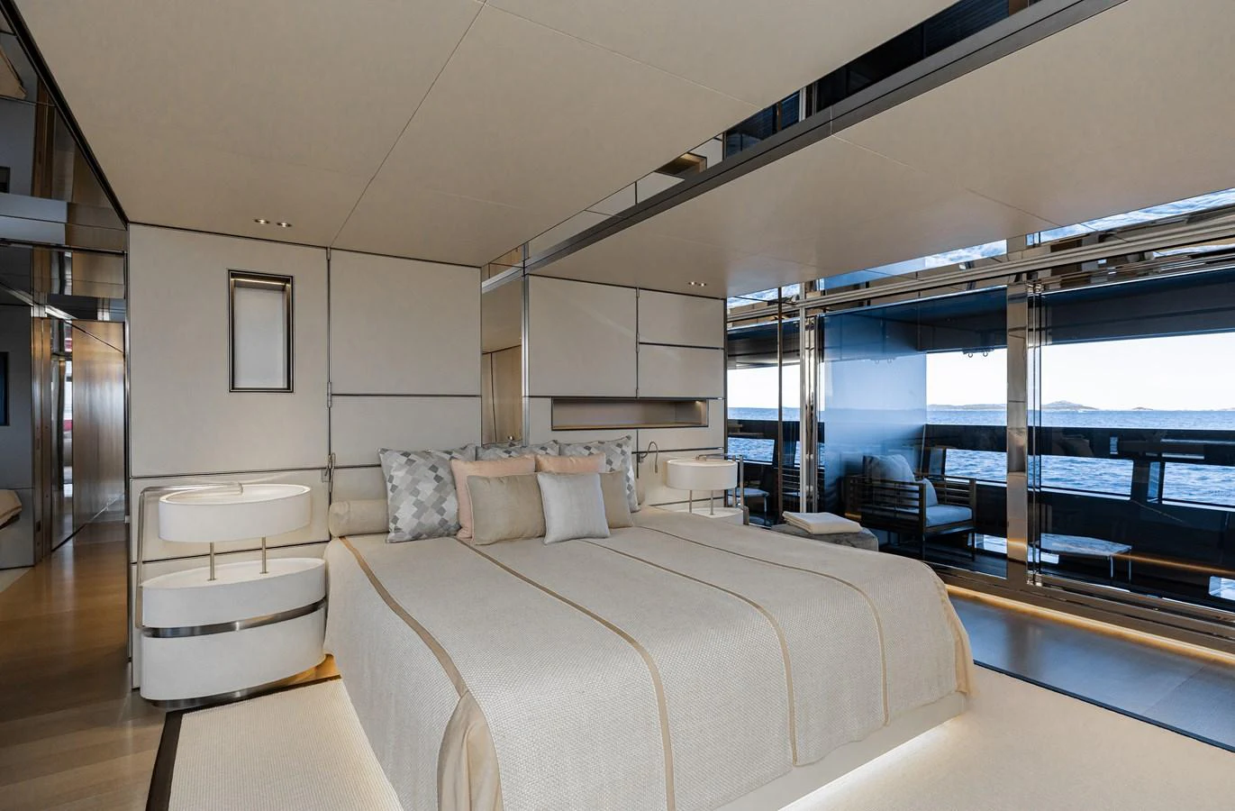 The master stateroom features a luxurious bed with elegant decor and expansive windows offering stunning ocean views. aboard FLYING DAGGER III Yacht for Sale