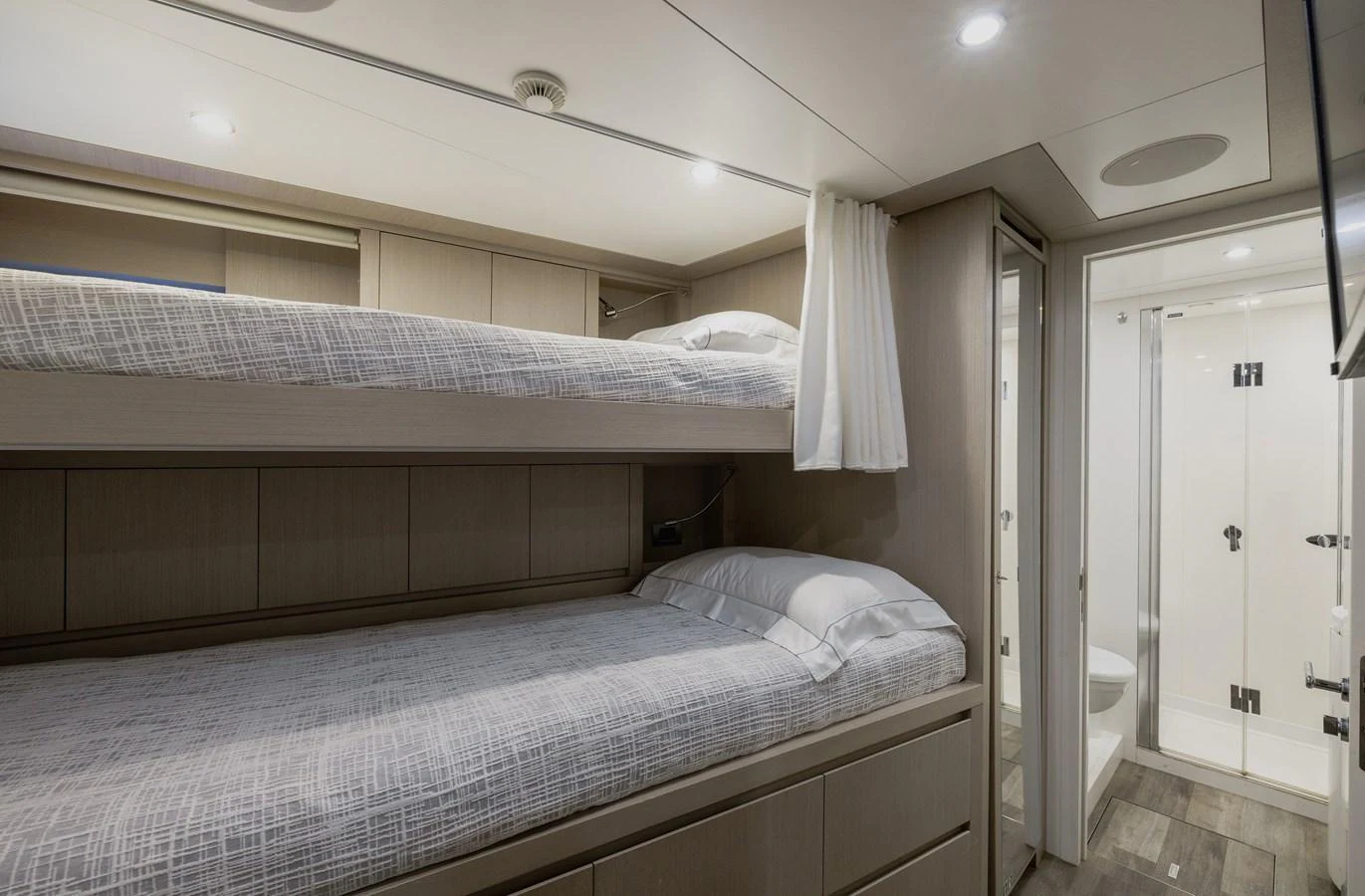 The guest cabin features cozy bunk beds and an ensuite bathroom, offering comfort and privacy. aboard FLYING DAGGER III Yacht for Sale