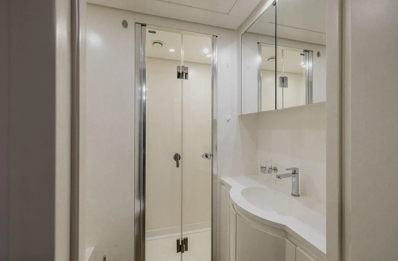 The yacht's bathroom features a sleek design with a modern sink and a glass-enclosed shower. aboard FLYING DAGGER III Yacht for Sale