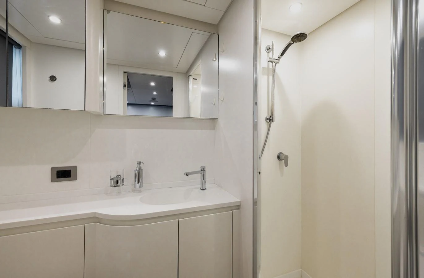 The yacht's bathroom features a sleek vanity and a modern shower area. aboard FLYING DAGGER III Yacht for Sale
