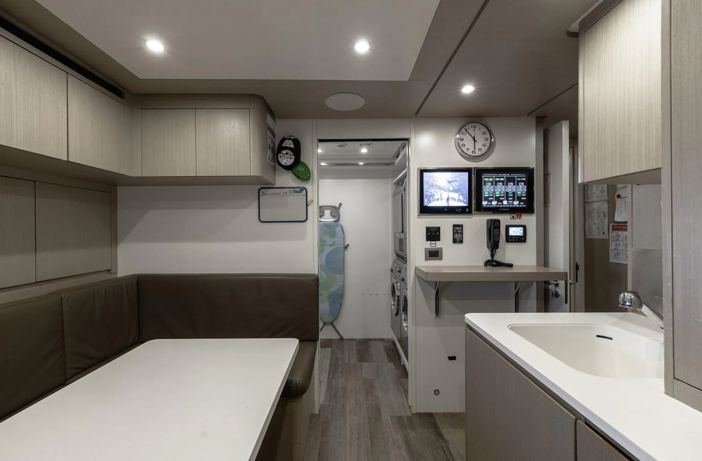 The galley features modern amenities and a cozy dining area with a sleek, minimalist design. aboard FLYING DAGGER III Yacht for Sale