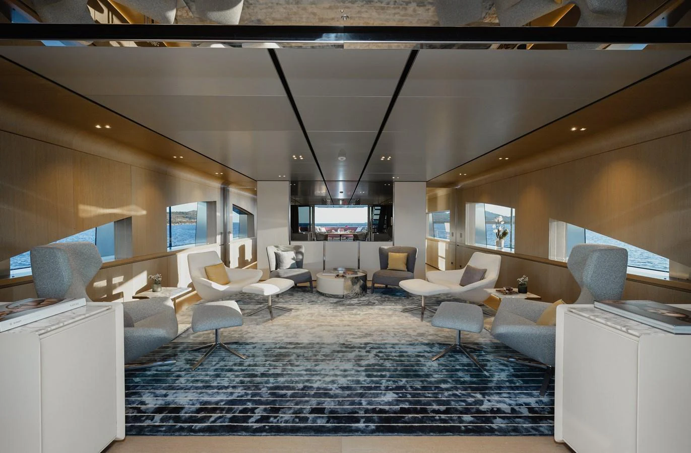 The salon features modern furnishings with ample seating and large windows offering stunning views. aboard FLYING DAGGER III Yacht for Sale