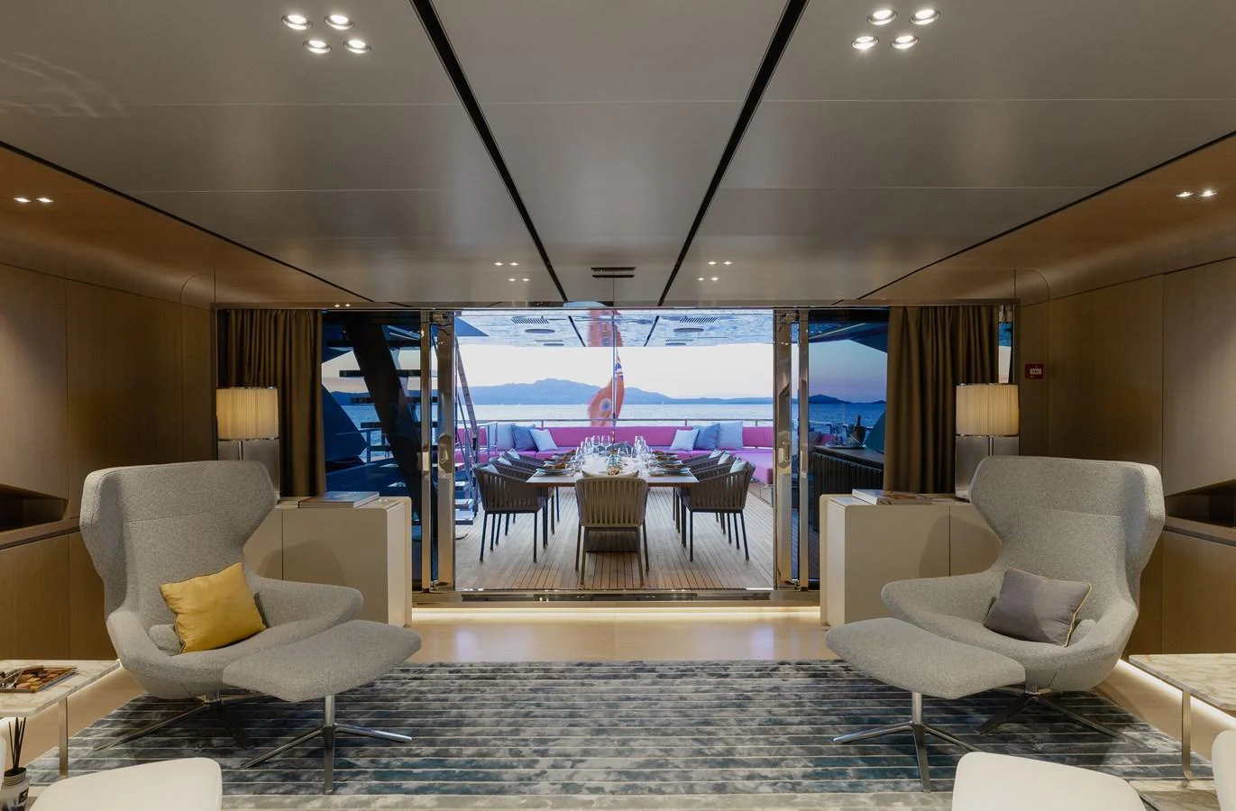 The yacht's salon features modern seating and opens to an elegant dining area on the aft deck. aboard FLYING DAGGER III Yacht for Sale