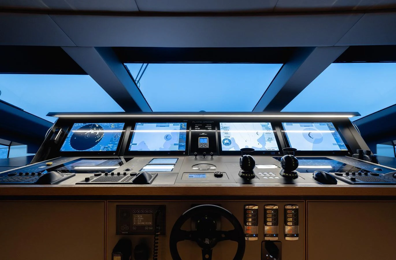 The helm station features advanced navigation and control systems with a panoramic view. aboard FLYING DAGGER III Yacht for Sale