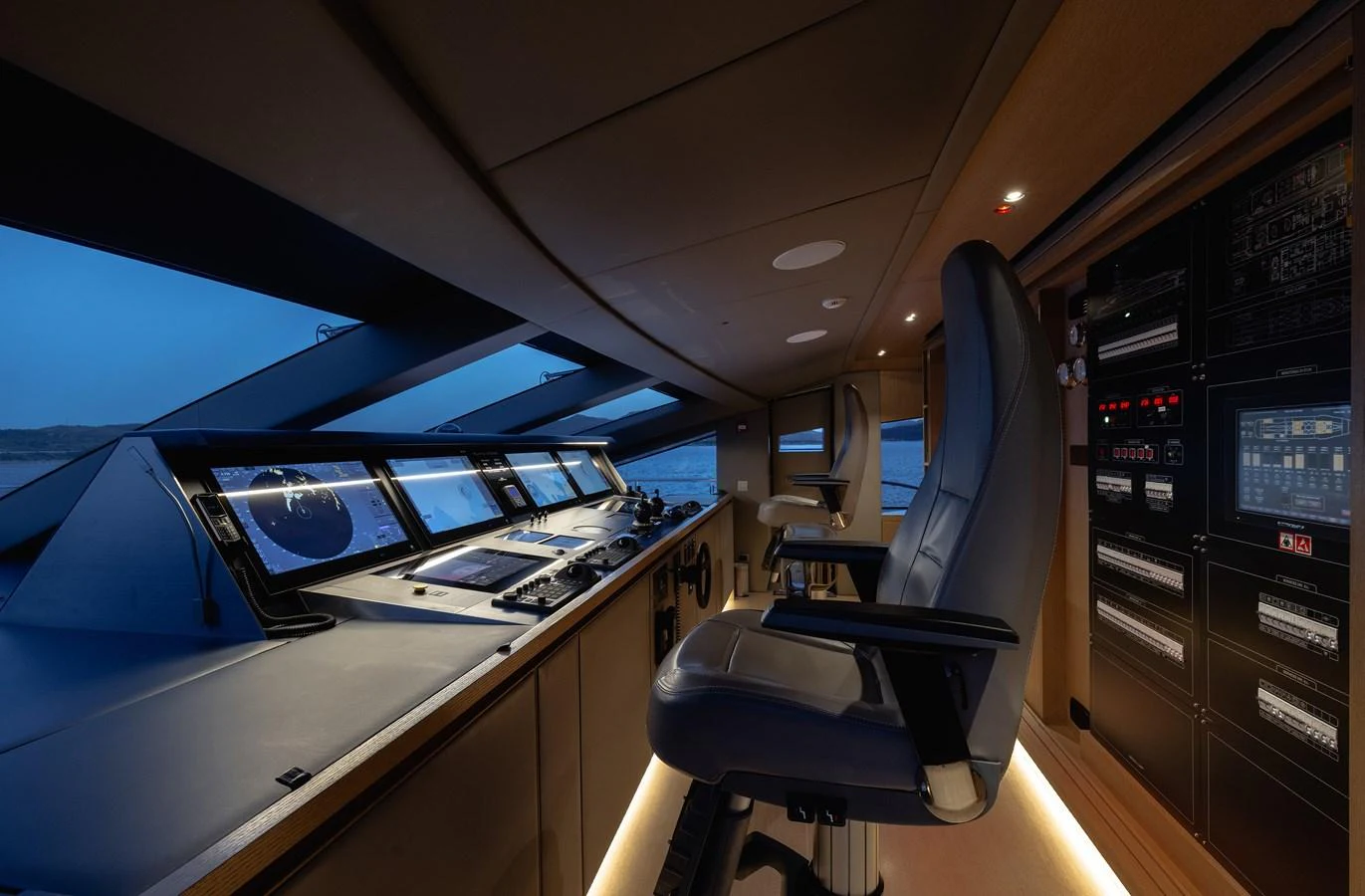 The helm station features advanced navigation equipment and a comfortable captain's chair, offering a commanding view of the surroundings. aboard FLYING DAGGER III Yacht for Sale