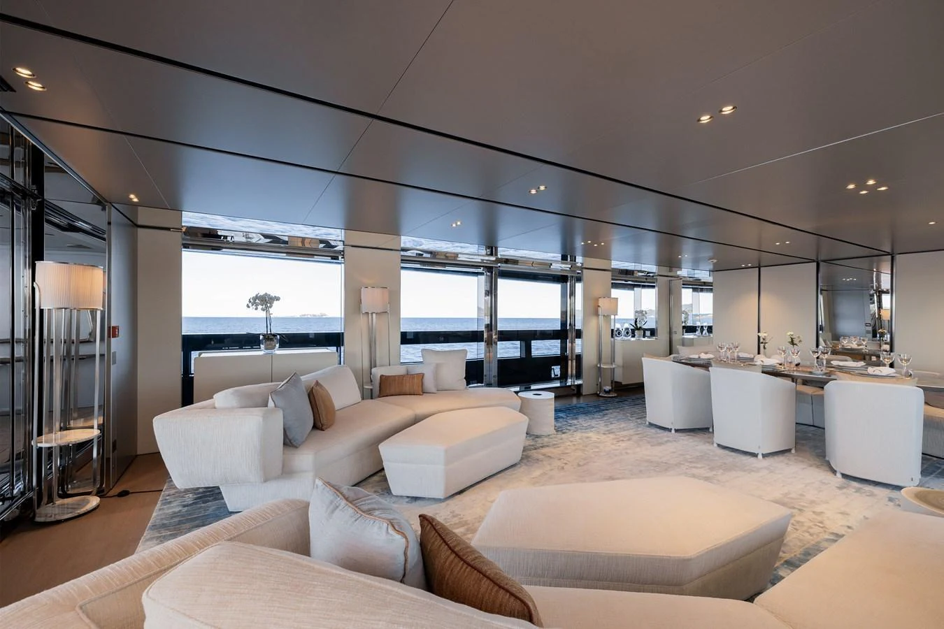 The spacious salon features elegant furnishings and panoramic windows offering stunning ocean views. aboard FLYING DAGGER III Yacht for Sale