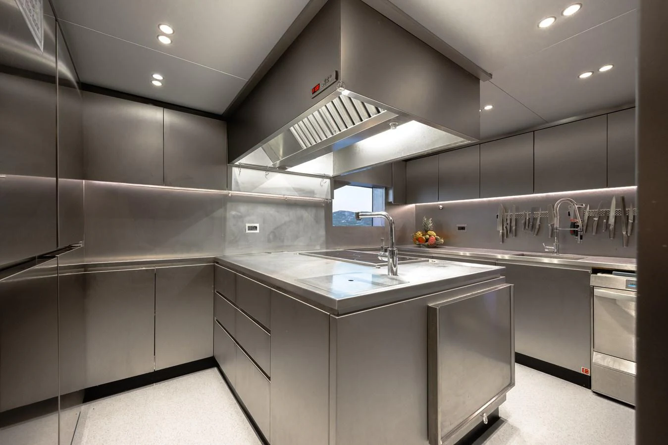 The yacht's galley features sleek stainless steel surfaces and modern appliances. aboard FLYING DAGGER III Yacht for Sale