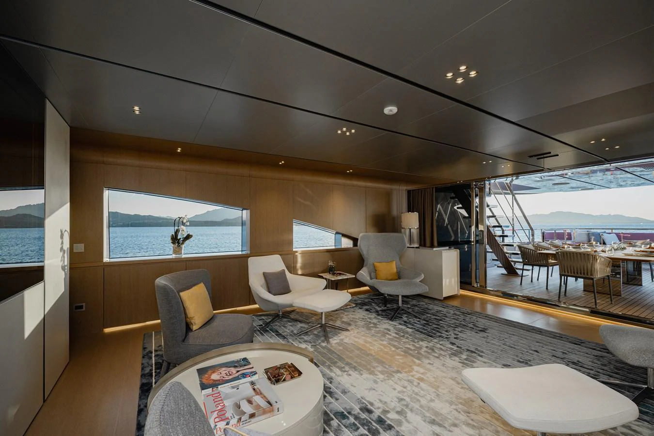 The salon offers a spacious and modern living area with large windows providing stunning sea views. aboard FLYING DAGGER III Yacht for Sale