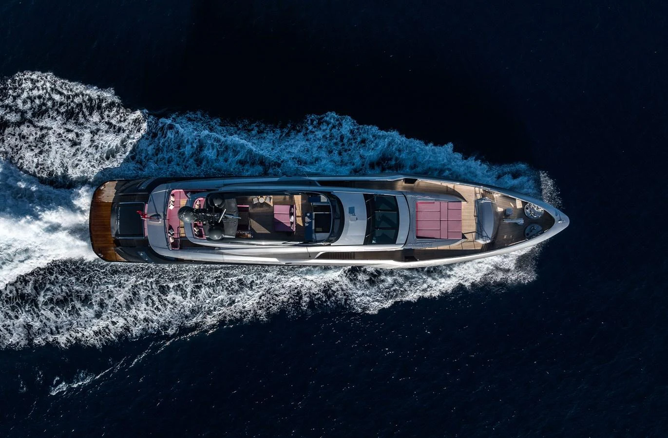 An aerial view of a sleek yacht cruising through deep blue waters, showcasing its elegant design and spacious deck areas. aboard FLYING DAGGER III Yacht for Sale
