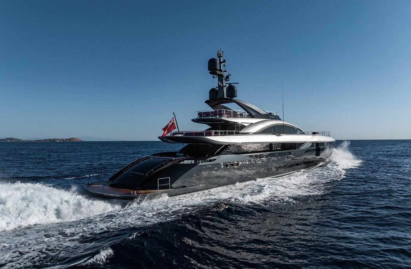 A sleek and modern yacht cruising on open water under a clear blue sky. aboard FLYING DAGGER III Yacht for Sale